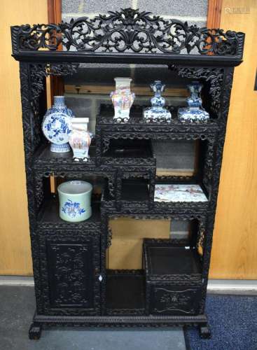 A 19TH CENTURY CHINESE HONGMU DISPLAY CABINET WITH FLORAL CA...