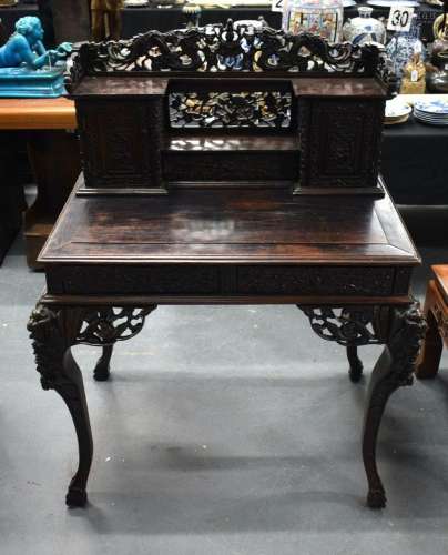 A 19TH CENTURY CHINESE HARDWOOD DESK CARVED WITH FLOWERS, BI...