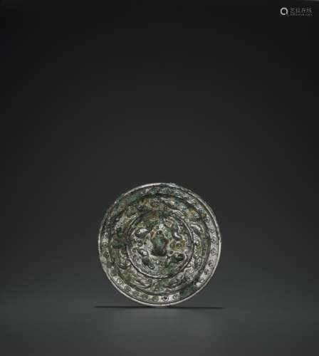 A RARE SILVERED BRONZE ‘LIONS AND GRAPEVINES’ MIRROR, TANG