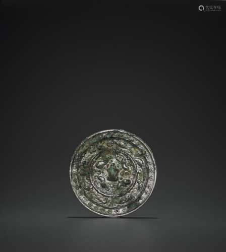 A RARE SILVERED BRONZE ‘LIONS AND GRAPEVINES’ MIRROR, TANG