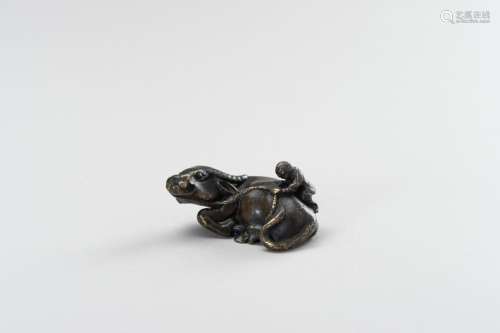 A FIGURAL BRONZE PAPERWEIGHT IN THE SHAPE OF A WATER BUFFALO...