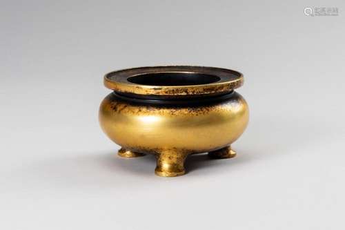 A SMALL GILT-BRONZE TRIPOD CENSER