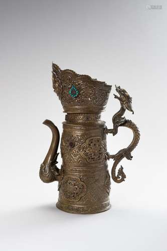 A BRASS REPOUSSÉ BEER EWER