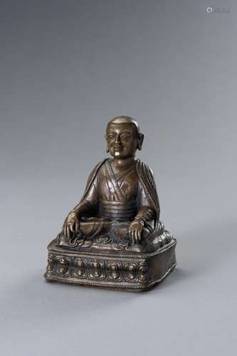 A BRONZE FIGURE OF A LAMA