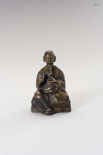 A BRONZE FIGURE OF A LAMA