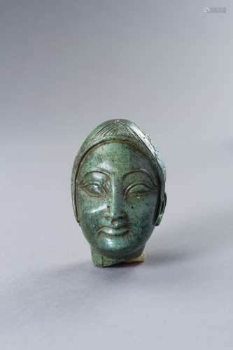 A GREEN STONE HEAD OF A FEMALE DEITY