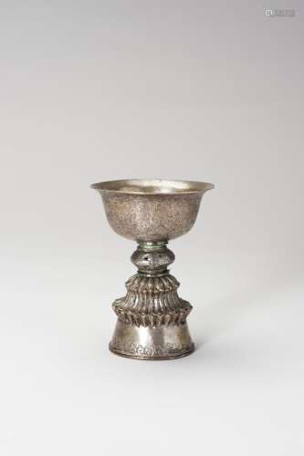 A CHASED SILVERED COPPER BUTTER LAMP