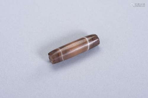 AN OLD TUBULAR ‘CHUNG DZI’ BROWNISH AGATE BEAD