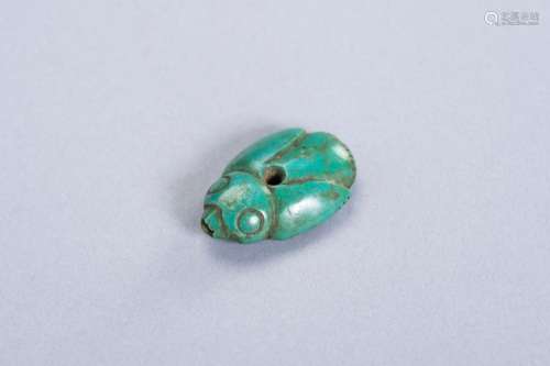 A TURQUOISE PENDANT OF A BIRD