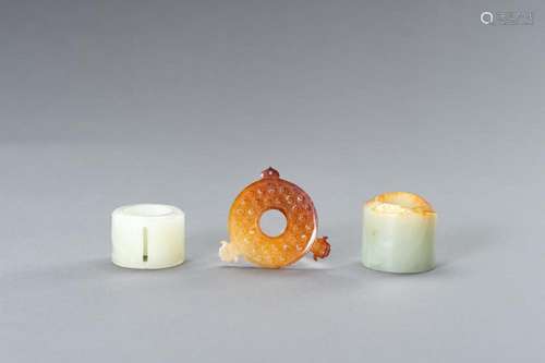 A JADE GROUP COMPRISING TWO ARCHER’S RINGS AND AN ARCHAISTIC...