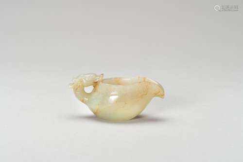 AN ARCHAISTIC CELADON JADE MINIATURE POURING VESSEL