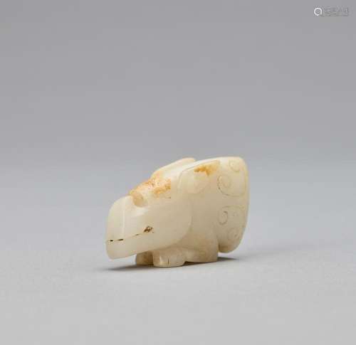 AN ARCHAISTIC WHITE JADE MYTHICAL BEAST HEAD, QING