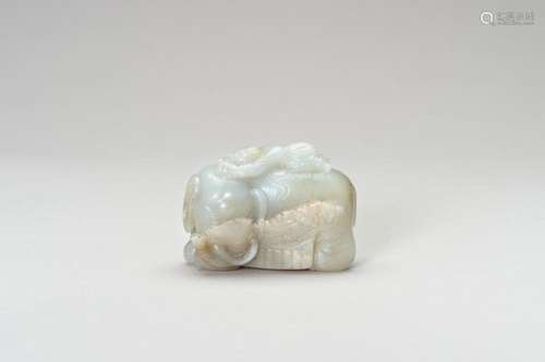 A PALE CELADON JADE CARVING OF AN ELEPHANT AND BOY