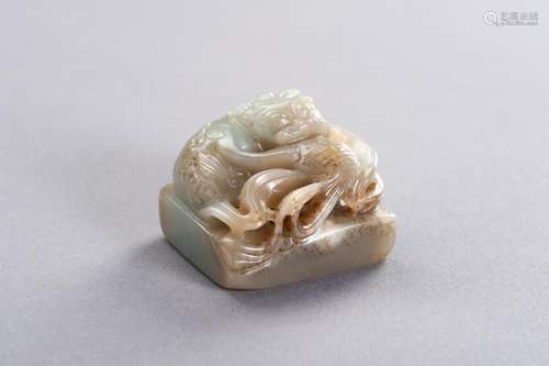 A CELADON AND RUSSET JADE ‘QILIN’ SEAL, LATE QING TO REPUBLI...