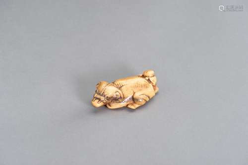 A STAG ANTLER NETSUKE OF AN OX AND OXHERD