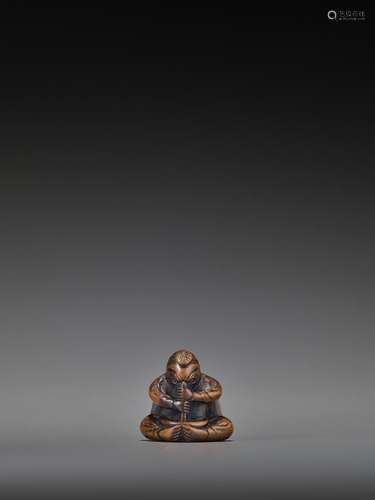 A WOOD NETSUKE OF A TENGU STIRRING MISO