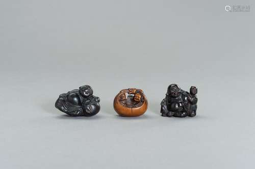 A GROUP OF THREE WOOD NETSUKE OF HOTEI