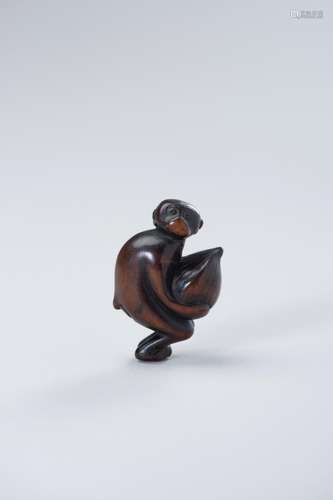 TWO WOOD NETSUKE OF A MONKEY WITH CHESTNUT