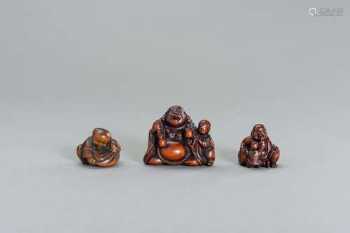 A GROUP OF THREE WOOD NETSUKE OF HOTEI AND KARAKO