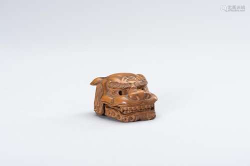 A WOOD MASK NETSUKE OF A SHISHI HEAD