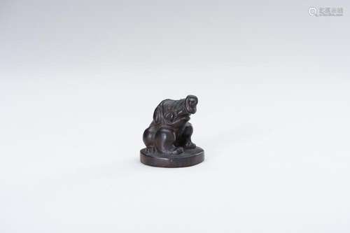 A WOOD NETSUKE OF BAKU ON A BASE