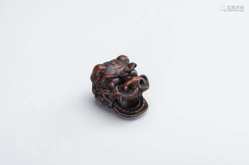 A LARGE WOOD MASK NETSUKE OF A SHISHI HEAD