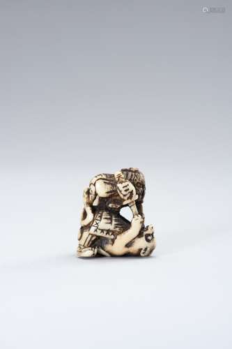 A STAG ANTLER NETSUKE OF HADESU SLAYING A TIGER