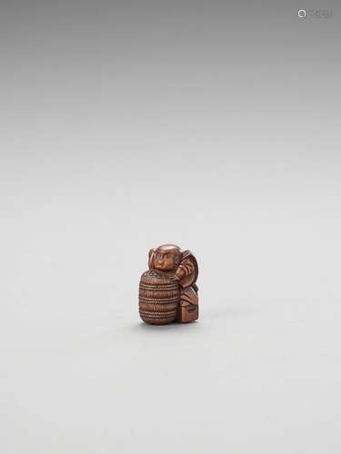 A WOOD NETSUKE OF FUKUSUKE WITH RICE BAIL