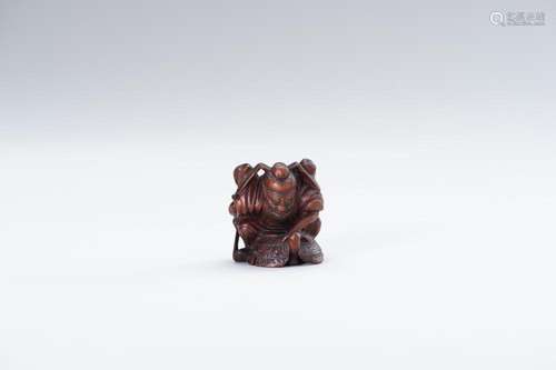 A WOOD NETSUKE OF SHOKI AND ONI