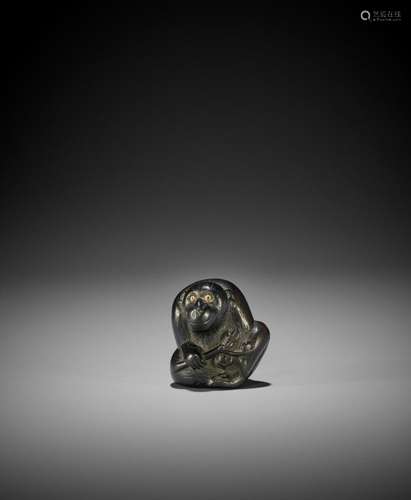 A TSU SCHOOL EBONY WOOD NETSUKE OF A MONKEY