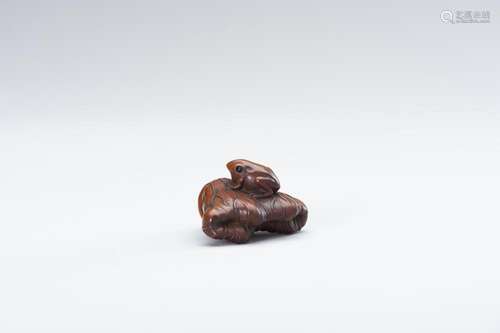 A WOOD NETSUKE OF A FROG AND LOTUS