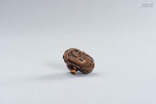 SADANOBU: A FINE WOOD NETSUKE OF A DRAGON INSIDE MIKAN