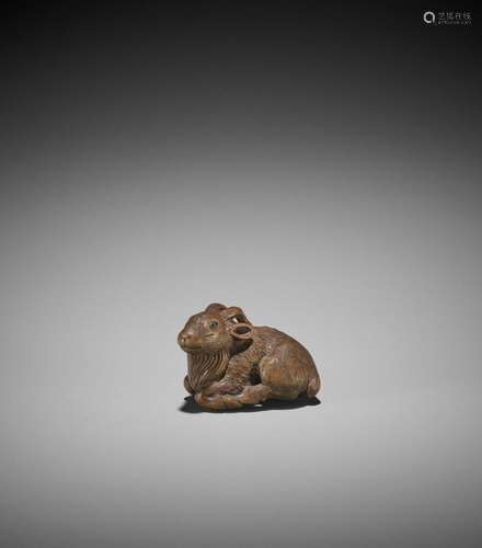 MINKO: A WOOD NETSUKE OF A RECUMBENT GOAT