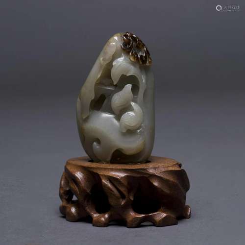 A CARVED JADE ORNAMENT WITH STAND