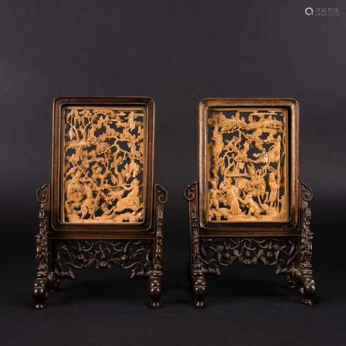 A PAIR OF CARVED HUANGYANG WOOD 'FIGURAL' TABLE SC...