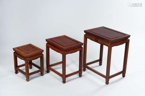 A FINE SET OF THREE REDDISH WOOD SIDE TABLES