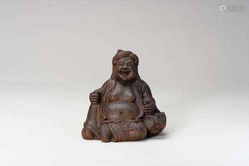 A WOOD FIGURE OF A LAUGHING BUDDHA