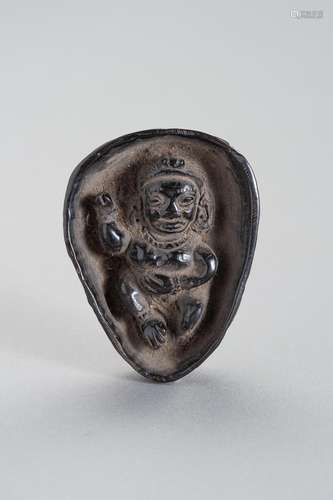 A HORN CARVING OF A BUDDHIST DEITY