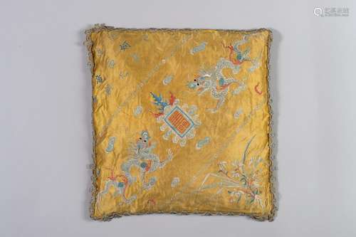 A YELLOW SILK CUSHION WITH DRAGONS