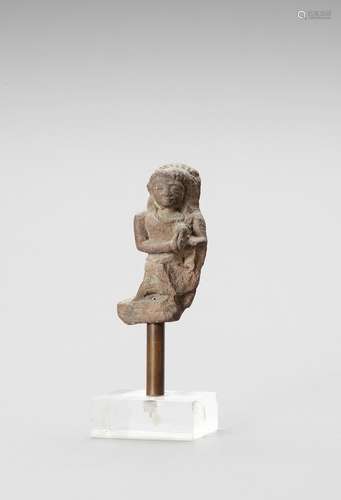 AN INDIAN RED SANDSTONE FRAGMENT DEPICTING A FEMALE WORSHIPP...