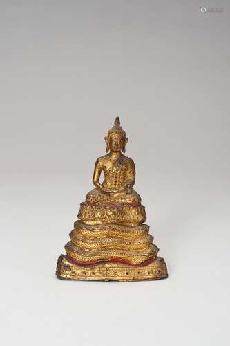 A SMALL LACQUER GILT BRONZE FIGURE OF A SEATED BUDDHA