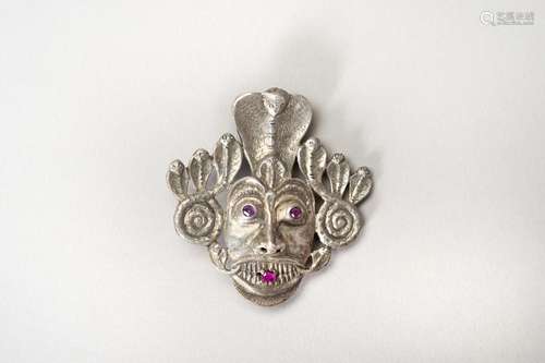 AN INLAID SILVER BROOCH OF MUCHALINDA