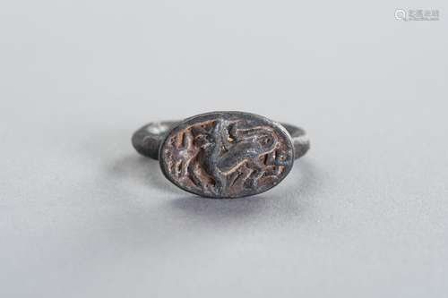 A BRONZE INTAGLIO RING DEPICTING A MYTHICAL BEAST