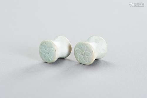 A PAIR OF STONE EARPLUGS