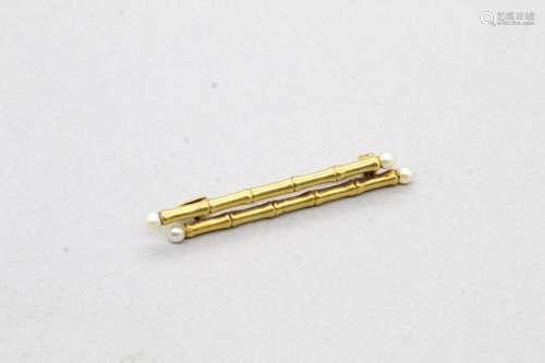 Broche bambou en or jaune 18k (750) ornée de quatre petites ...