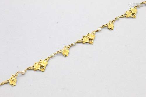 Collier en or jaune 18k (750) formé de feuilles entrecoupé d...