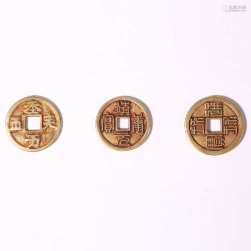 Three gilt coins with lettering