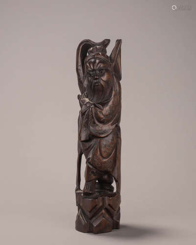 A rosewood silver-inlaid figurine