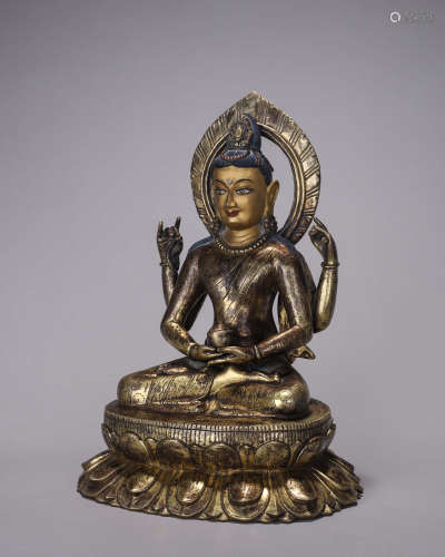 A copper four-armed Guanyin statue