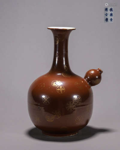 A gilt brown glazed porcelain ewer